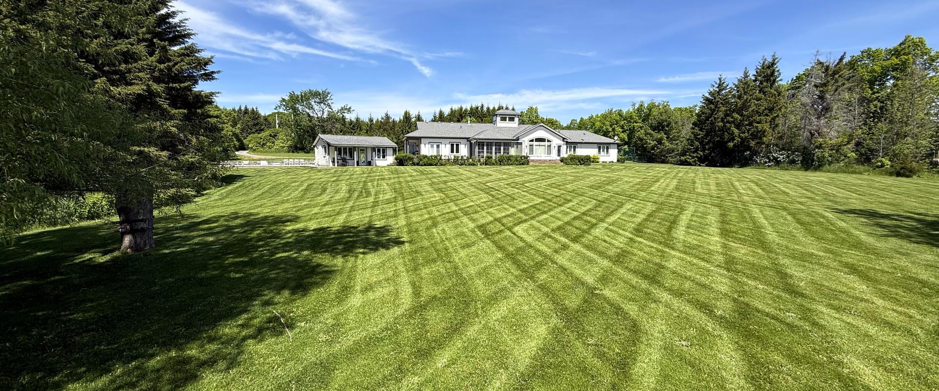 Wide, freshly striped lawn in front of a country estate